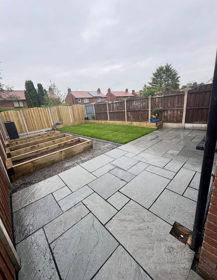 Finished paved garden with lawn and timber borders